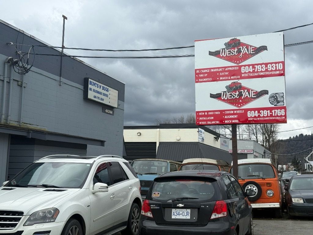 West Yale roadside sign listing the automotive and tire phone numbers