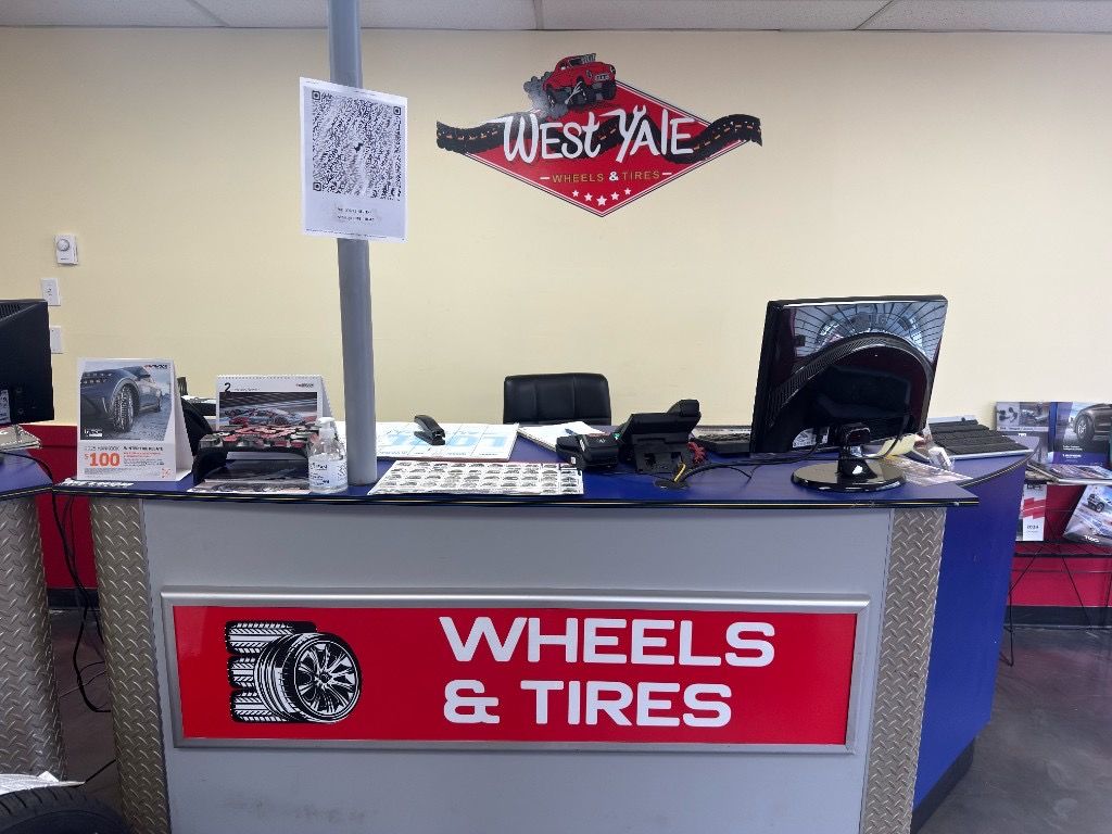 West Yale Wheels & Tires counter with the red wall logo